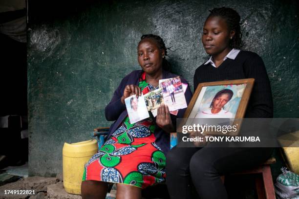 Rose Wanjiku reacts as she sits outside her residence with a relative looking at photos of her belated sister, Agnes, in Nanyuki town, Laikipia...