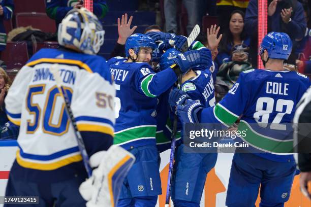 Ilya Mikheyev of the Vancouver Canucks is congratulated after scoring a goal on Jordan Binnington of the St. Louis Blues during the third period of...