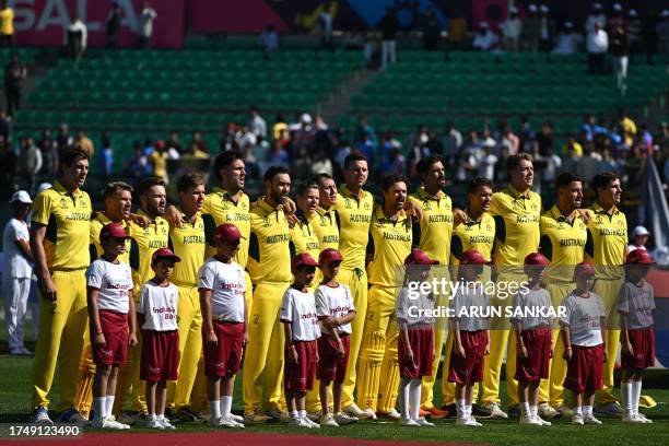 Australia's players stand for their national anthem before the start of the 2023 ICC Men's Cricket World Cup one-day international match between...