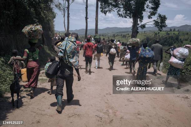 Residents of Bambo in Rutshuru territory, 60 kilometers north of Goma, the capital of North Kivu, eastern Democratic Republic of Congo, flee as the...