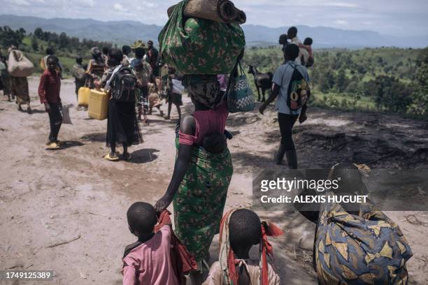Residents of Bambo in Rutshuru territory, 60 kilometers north of Goma, the capital of North Kivu, eastern Democratic Republic of Congo, flee as the...