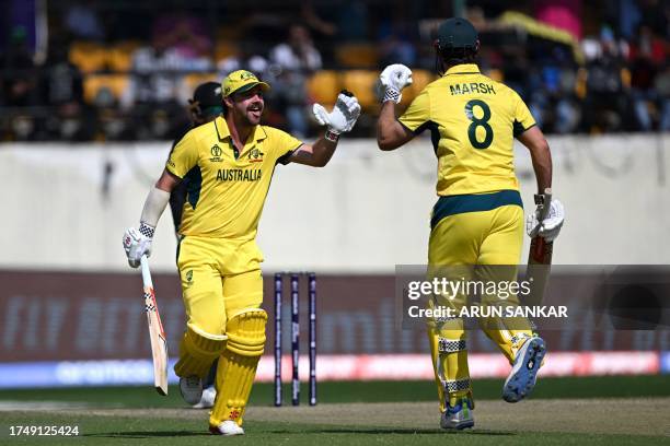 Australia's Travis Head celebrates with teammate Mitchell Marsh after scoring a century during the 2023 ICC Men's Cricket World Cup one-day...