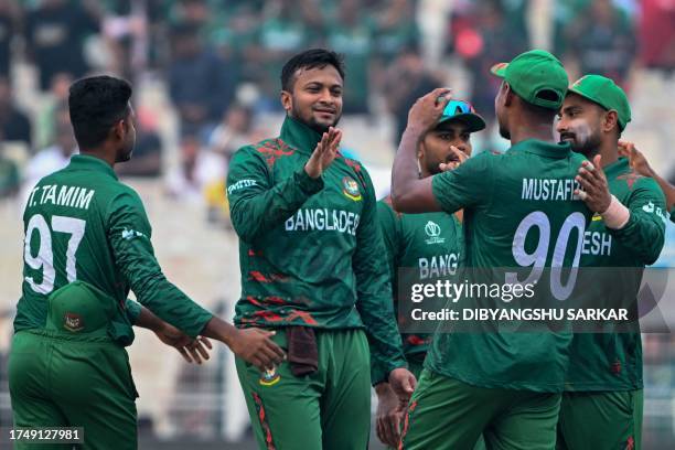 Bangladesh's captain Shakib Al Hasan celebrates with teammates after taking the wicket of Netherlands' Colin Ackermann during the 2023 ICC Men's...