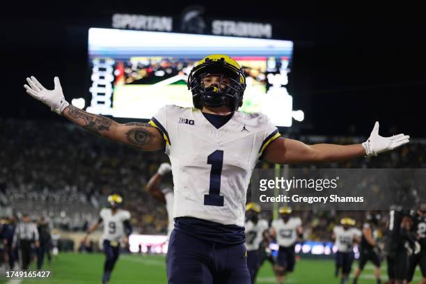 Roman Wilson of the Michigan Wolverines celebrates a first half touchdown against the Michigan State Spartans at Spartan Stadium on October 21, 2023...