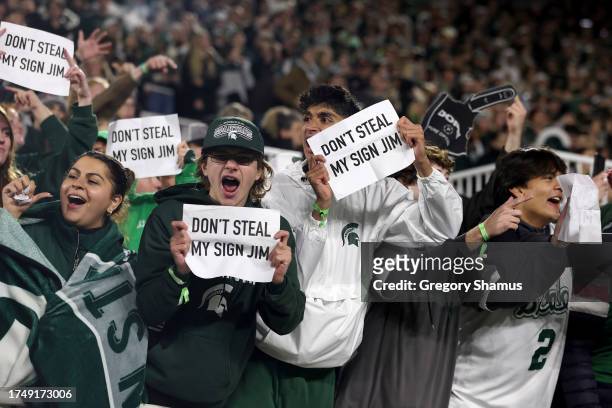 Michigan State Spartans student section hold up signs after sign stealing reports the Michigan Wolverines have surfaced at Spartan Stadium on October...