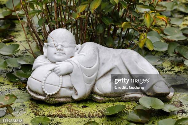 Phat Quang Buddhist temple. Marble buddhist monk statue in garden. Chau Doc. Vietnam.