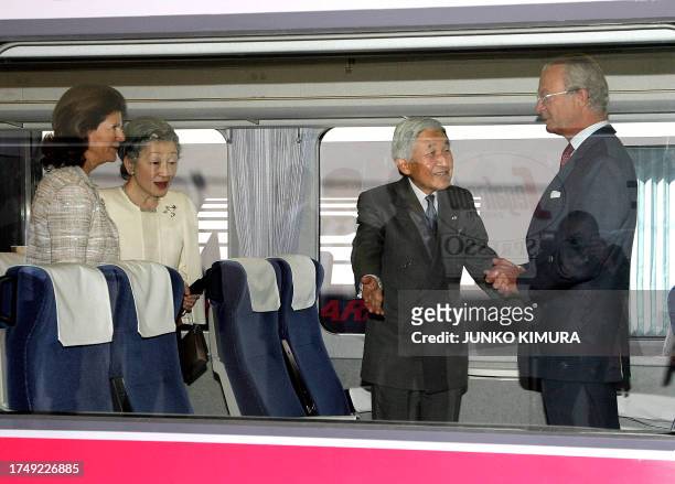 Japanese Emperor Akihito offers a seat to Swedish King Carl XVI Gustaf on the train, accompanied by Japanese Empress Michiko and Swedish Queen Silvia...