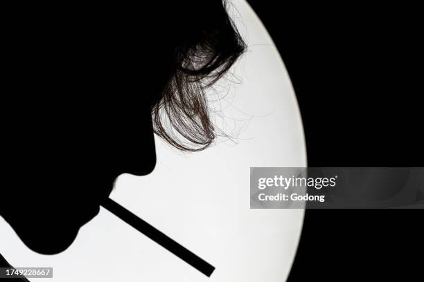 Profile Silhouette of a Man Smoking on White Background.