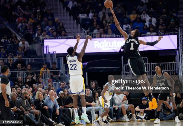 Victor Wembanyama of the San Antonio Spurs blocks the shot of Andrew Wiggins of the Golden State Warriors during the first half of an NBA basketball...
