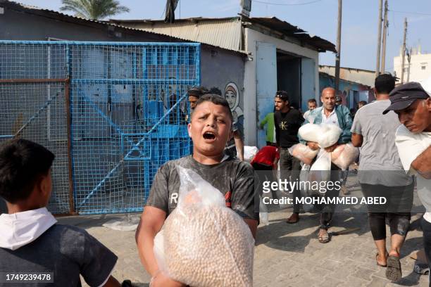 Palestinians storm a UN-run aid supply center, that distributes food to displaced families following Israel's call for more than one million...