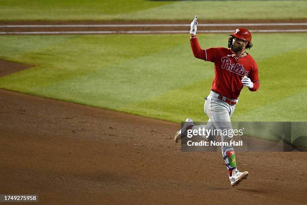 Bryce Harper of the Philadelphia Phillies celebrates as he rounds the bases after hitting a solo home run against Zac Gallen of the Arizona...