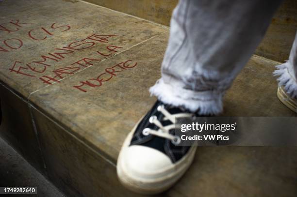 Women write a graffiti that reads 'Feminist Until I Die' as women participate in the international women's day demonstrations in Bogota, Colombia on...