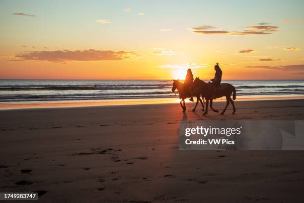Horse riding at sunset in Jiquilillo beach, Chinandega, Nicaragua.