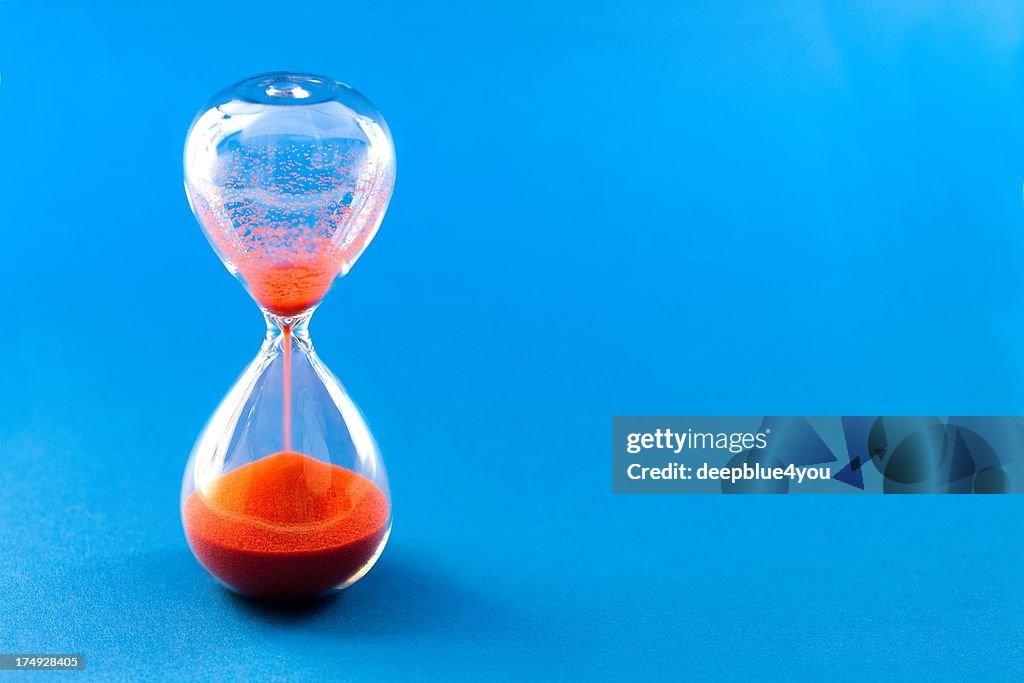 Red hourglass on blue background