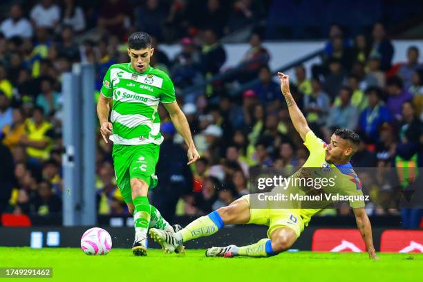 Juan Brunetta of Santos struggles for the ball against Jonathan Dos Santos of America during the 13th round match between America and Santos Laguna...