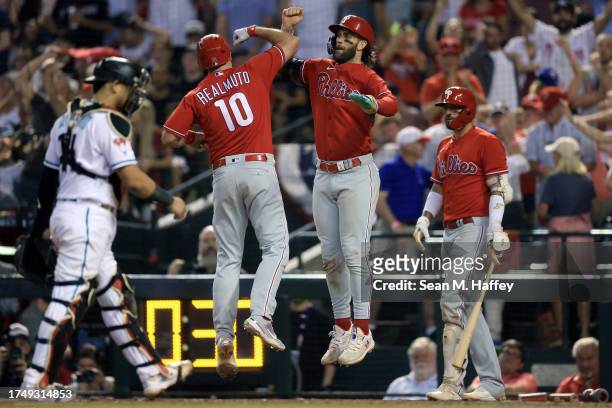 Realmuto of the Philadelphia Phillies celebrates with Bryce Harper after hitting a two run home run against Luis Frias of the Arizona Diamondbacks...