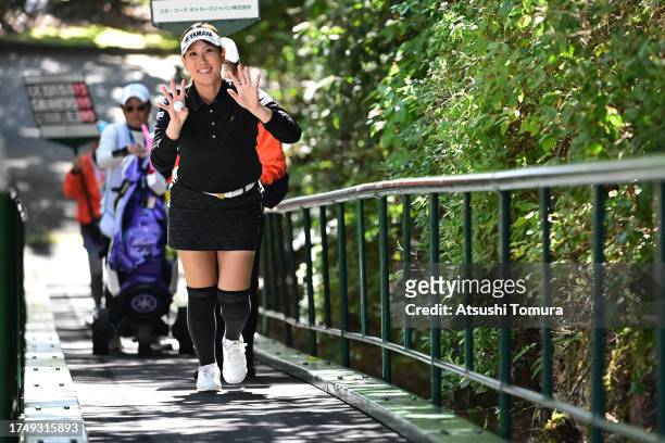Mami Fukuda of Japan waves on her way to the 8th tee during the final round of NOBUTA Group Masters GC Ladies at Masters Golf Club on October 22,...