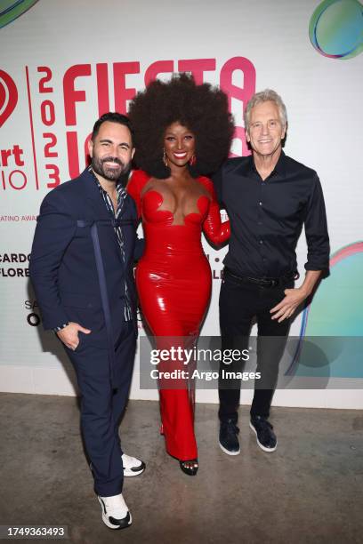 Enrique Santos, Amara La Negra and John Sykes attend the 2023 iHeart Fiesta Latina at Kaseya Center on October 21, 2023 in Miami, Florida.