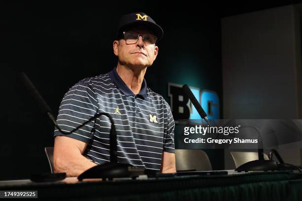 Head coach Jim Harbaugh of the Michigan Wolverines talks to the media after a 49-0 win over the Michigan State Spartans at Spartan Stadium on October...