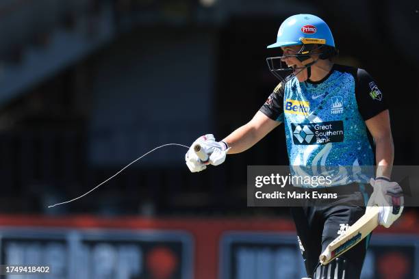 Grace Harris of the Heat laughs as she shows her broken bat during the WBBL match between Perth Scorchers and Brisbane Heat at North Sydney Oval, on...