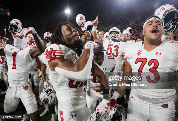 Landen King and Tanoa Togiai of the Utah Utes celebrate their win over the USC Trojans at United Airlines Field at the Los Angeles Memorial Coliseum...