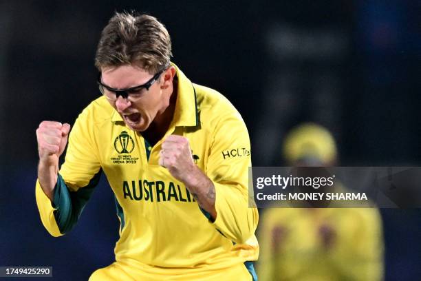 Australia's Adam Zampa celebrates after taking the wicket of New Zealand's Mitchell Santner during the 2023 ICC Men's Cricket World Cup one-day...