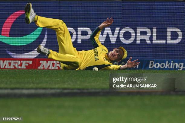 Australia's Marnus Labuschagne dives to stop a boundary during the 2023 ICC Men's Cricket World Cup one-day international match between Australia and...