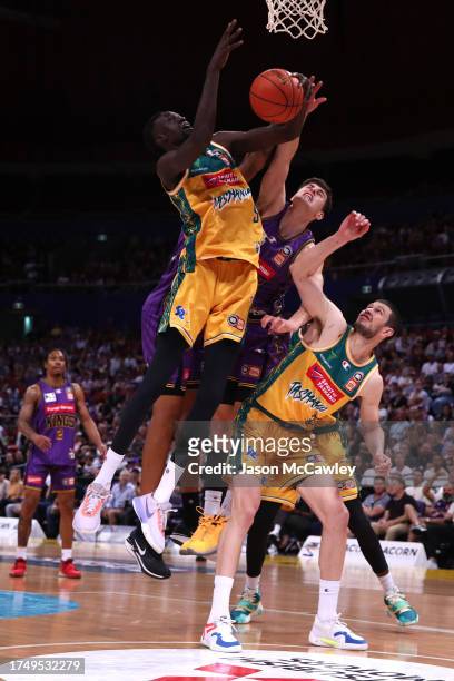 Majok Deng of the JackJumpers and Alex Toohey of the Kings compete for the ball during the round four NBL match between Sydney Kings and Tasmania...