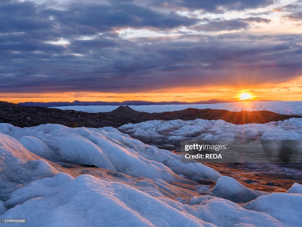 Ice In Sun Midnight sun on the ice sheet. The brown sediment on the ice is... News ...