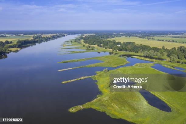 Aerial view over the river Elbe flowing through the Lower Saxon Elbe Valley Biosphere Reserve in summer, Lower Saxony. Niedersachsen, Germany.