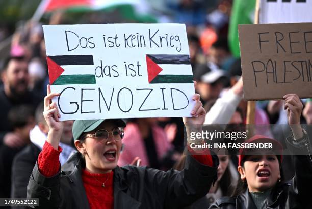 Protester holds a placard with the lettering reading 'This is no war, this is genocide' during a 'March for Palestine' in Dortmund, western Germany...