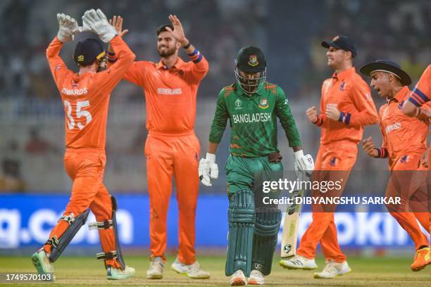 Bangladesh's Liton Das gestures as Netherlands' players celebrate after his dismissal during the 2023 ICC Men's Cricket World Cup one-day...