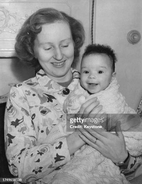 British bank clerk Ruth Williams Khama and her daughter, Jacqueline Khama, relax in their new home after six weeks of househunting in south London,...