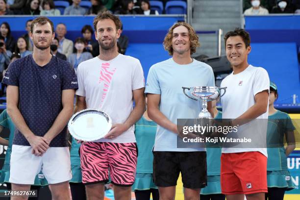 Jamie Murray of Great Britain and Michael Venus of New Zealand pose with the runner-up trophy as Rinky Hijikata and Max Purcell of Australia pose...