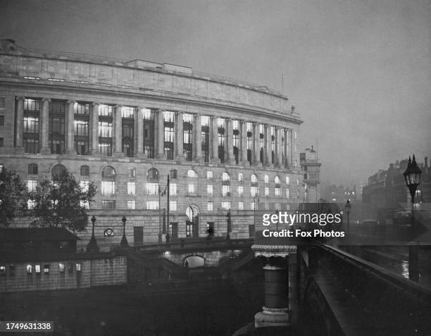 The curved facade of Unilever House, Unilever's London headquarters, under a gloomy sky at midday, on New Bridge Street, with Blackfriars Bridge to...
