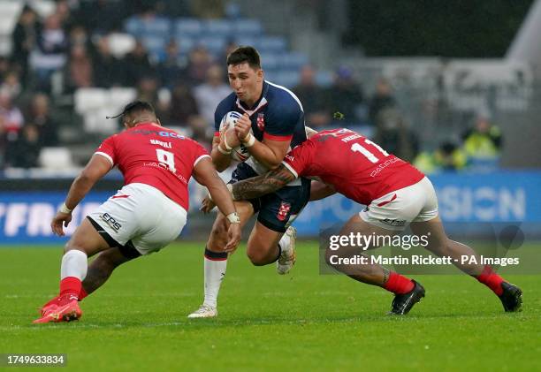 England's Victor Radley is tackled by Tonga's Siliva Havili and Tyson Frizell during the International Test Series match at John Smith's Stadium,...