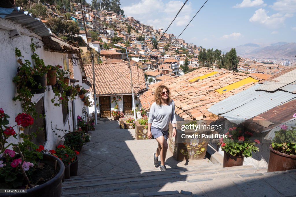 Women walking up an alley in the San Blas neigbhorhood of Cusco, Peru