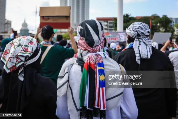 Demonstrator wears a headscarf with the Palestinian and Malaysian flag during a Freedom for Palestine rally at Merdeka Square on October 22 in Kuala...