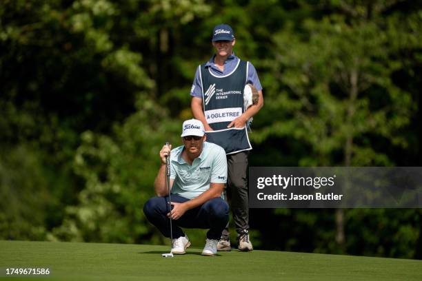 Andy Ogletree of the USA and his caddie line up a putt on hole 7 during the third round of the Asian Tour International Series England at Close House...