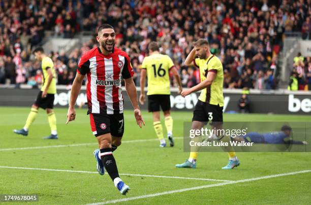 Neal Maupay of Brentford celebrates as Yoane Wissa of Brentford scores the team's first goal during the Premier League match between Brentford FC and...