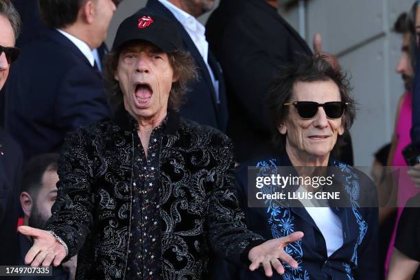 Members of the English rock band The Rolling Stones, Mick Jagger and Ronnie Wood, attend the Spanish league football match between FC Barcelona and...