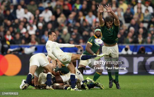 Alex Mitchell of England box kicks the ball under pressure from Eben Etzebeth of South Africa during the Rugby World Cup France 2023 match between...