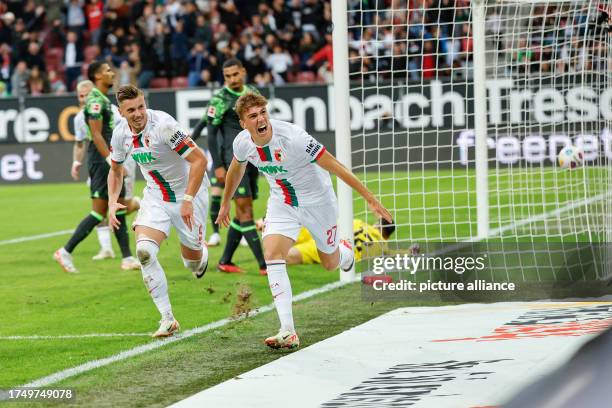 October 2023, Bavaria, Augsburg: Soccer, Bundesliga, FC Augsburg - VfL Wolfsburg, Matchday 9, WWK Arena. Augsburg scorer Arne Engels celebrates with...