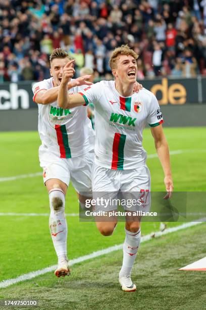 October 2023, Bavaria, Augsburg: Soccer, Bundesliga, FC Augsburg - VfL Wolfsburg, Matchday 9, WWK Arena. Augsburg scorer Arne Engels celebrates with...