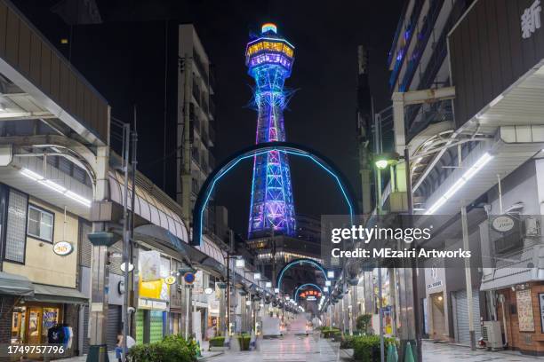 night scene at shinsekai district in osaka japan. the district is famous with street food stall, overlooking famous osaka tower tsutenkaku. - osaka shinsekai food stock-fotos und bilder