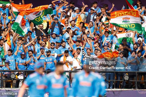 India fans celebrate the wicket of Devon Conway of New Zealand during the ICC Men's Cricket World Cup India 2023 match between India and New Zealand...