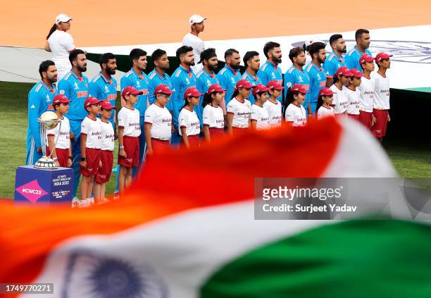 The India team line up for the National Anthems ahead of the ICC Men's Cricket World Cup India 2023 match between India and New Zealand at HPCA...