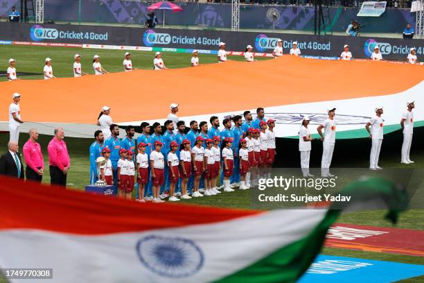 The India team line up for the National Anthems ahead of the ICC Men's Cricket World Cup India 2023 match between India and New Zealand at HPCA...