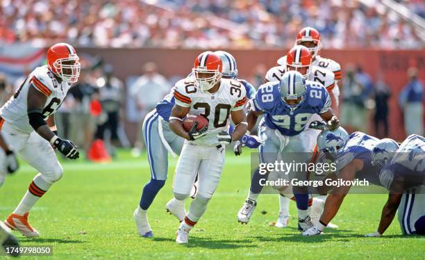 Running back Jamel White of the Cleveland Browns runs with the football as he is pursued by safety Ron Rice and other Detroit Lions as tackle Roger...