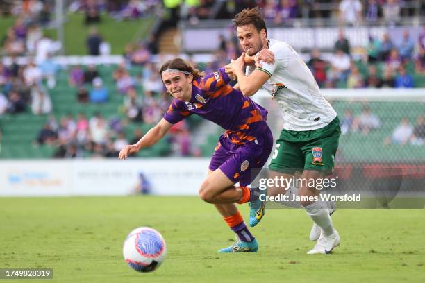 Daniel Bennie of the Glory and Carl Jenkinson of the Jets tussle with each other as they chase down the ball during the A-League Men round one match...